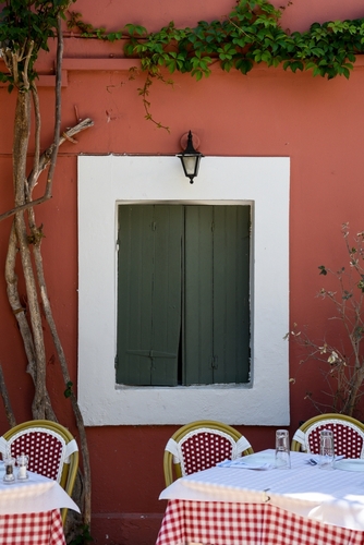Two,Empty,Tables,With,Red,Checkered,Tablecloths,Sit,Outside,A
