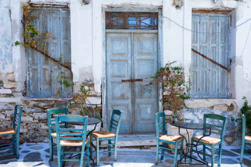 Traditional,,Greek,,Coffee,Table,Chairs,In,Front,Of,An,Old,