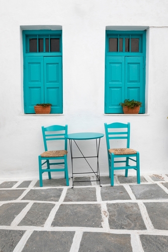 Typical,Greek,Cafe,Table,And,Chairs,With,Shuttered,Windows,,Pano
