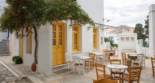 Greece.,Tinos,Island,Cyclades.,Outdoors,Traditional,Cafe,With,Yellow,Windows