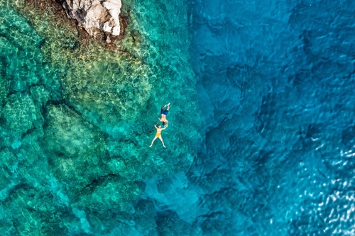 Aerial,View,Of,A,Young,Couple,Snorkeling,Above,Coral,Reef, rhodes